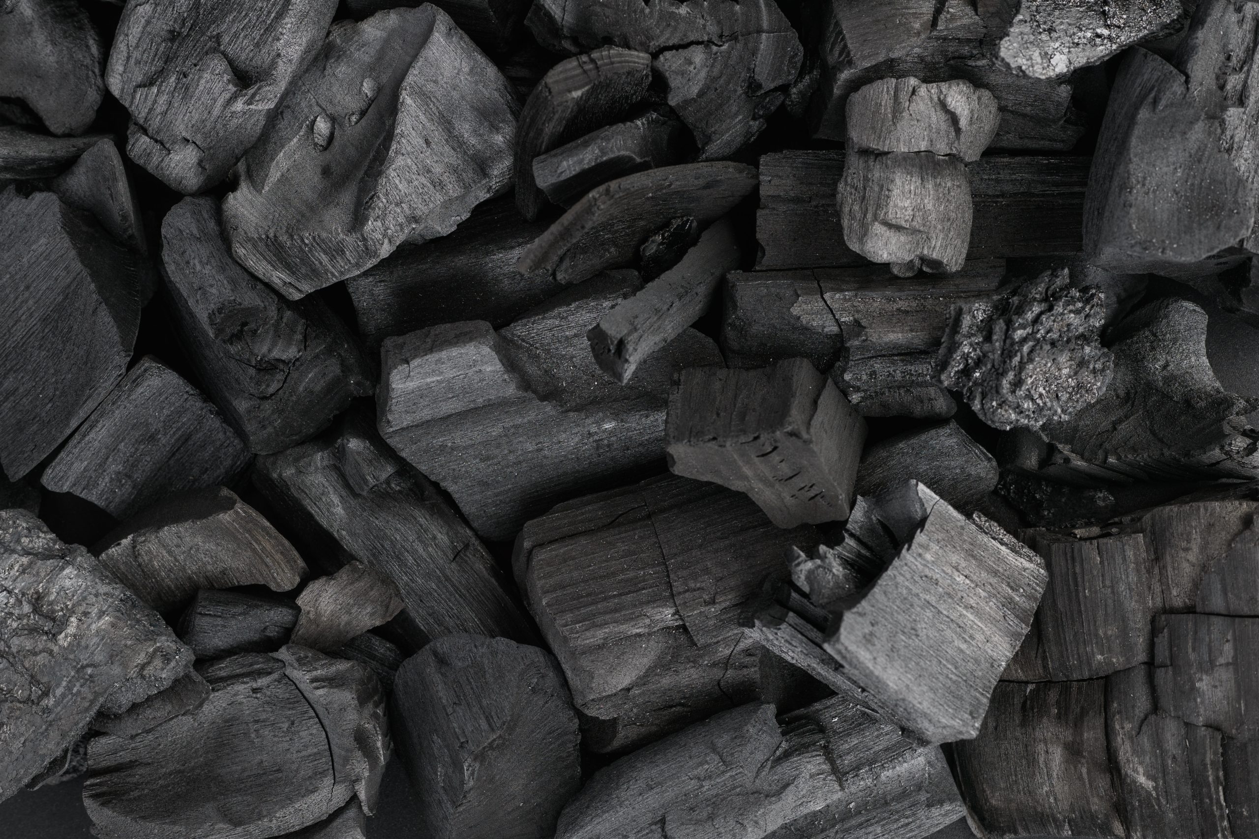 Black charcoal texture background. Close-up. Top view.